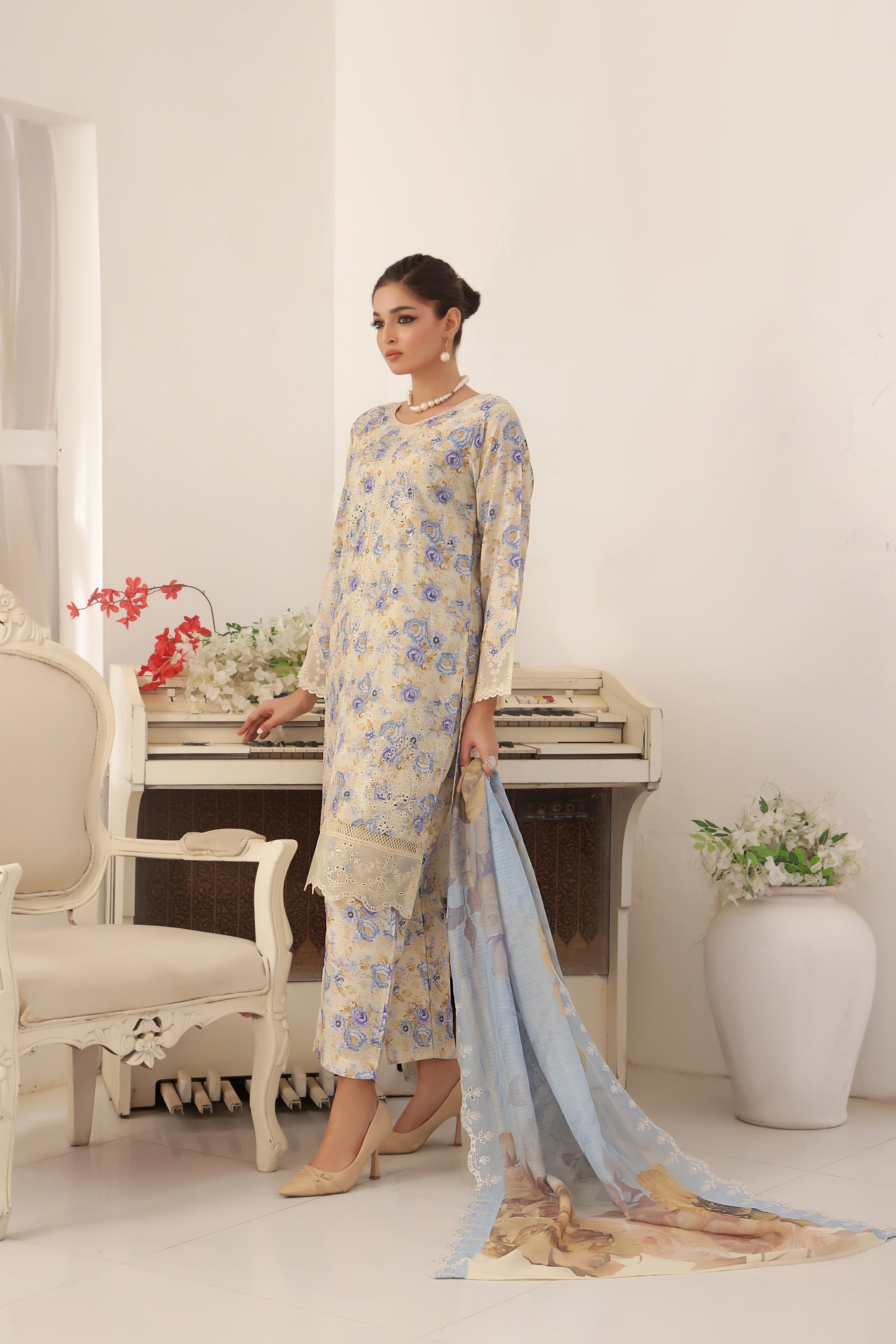 ZARNAZ - Woman in a Gray with Creamy White Base floral dress with a matching dupatta in a decorated room
