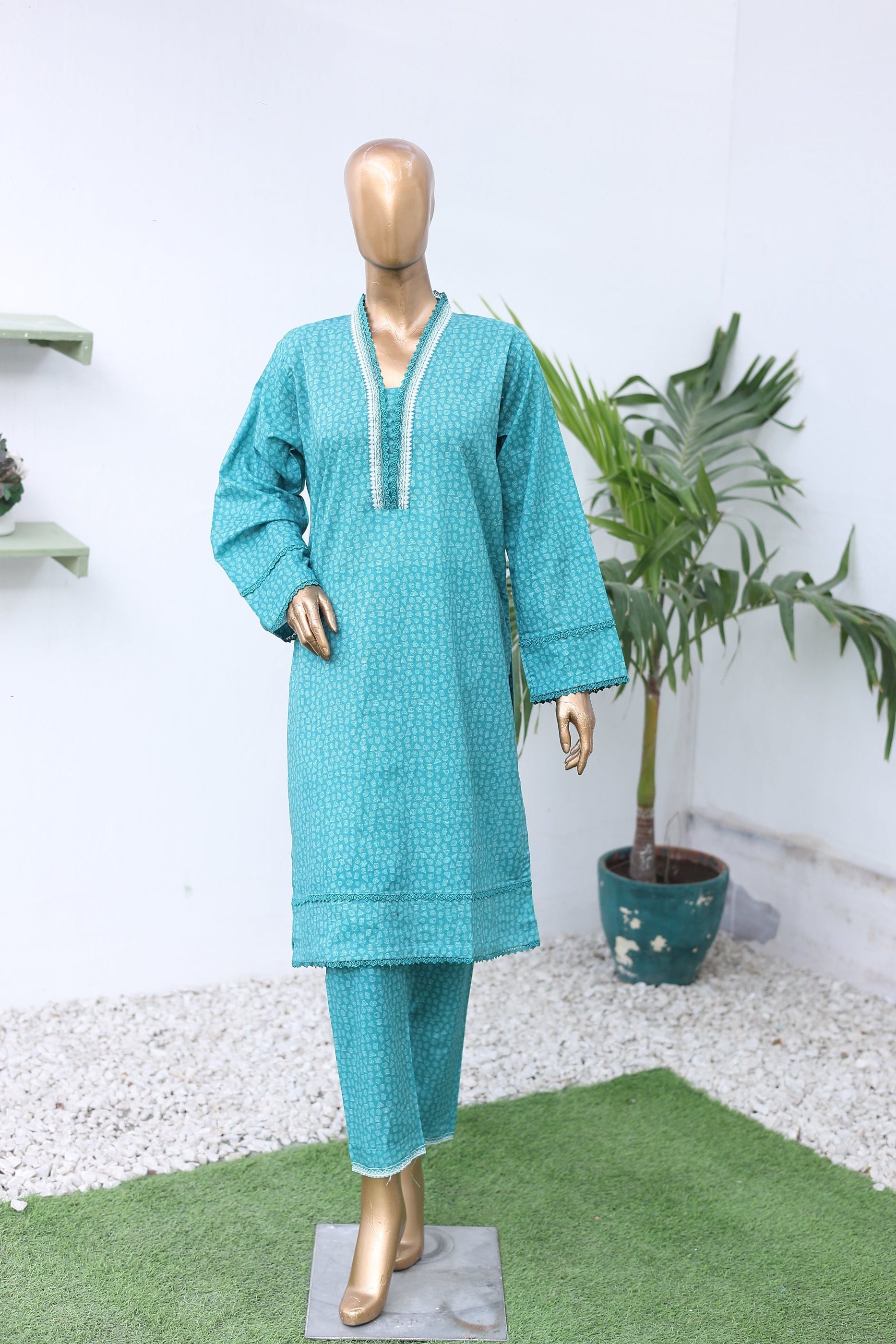 Teal jacket on a mannequin with gold shoes against a white background