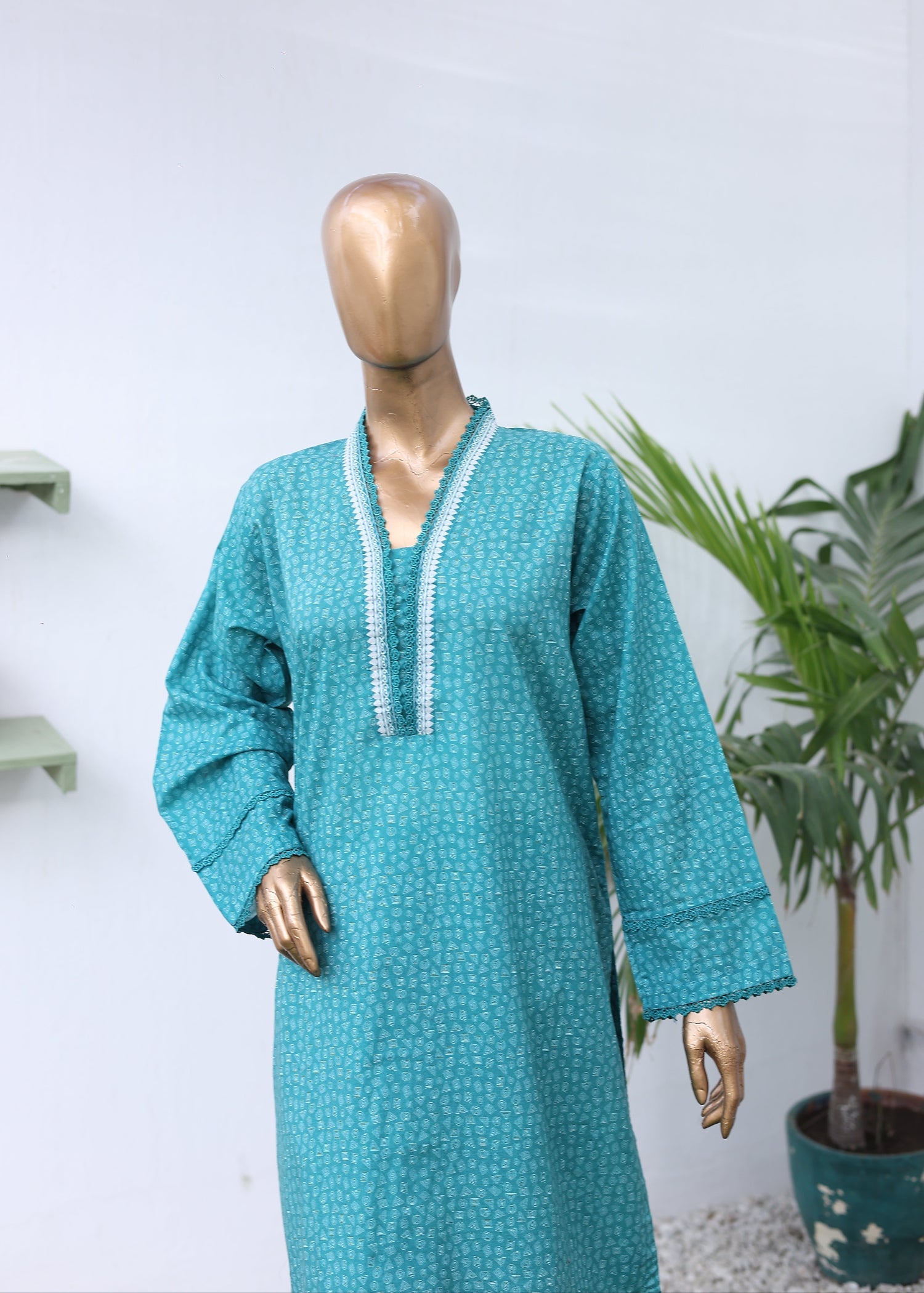 Teal outfit on a mannequin with a white background