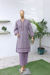 Mannequin wearing a purple outfit with a white background and plant