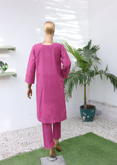 Mannequin wearing a bright pink outfit with a plant on a white background