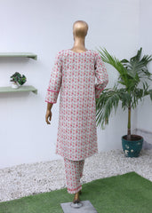 Mannequin wearing a red and white patterned dress on a white background with plants.